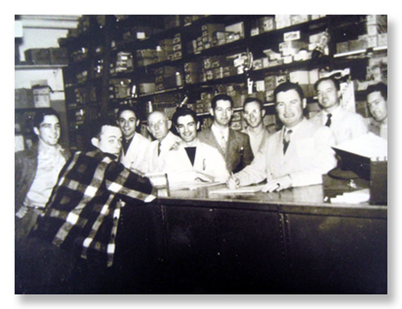 Frank P. McCartin and team behind the Lowell counter in 1947